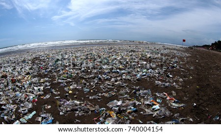 Garbage cover the beach in bali during high tourist season showing the extent of the pollution problem in Indonesian waters Royalty-Free Stock Photo #740004154