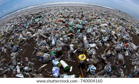 Garbage cover the beach in bali during high tourist season showing the extent of the pollution problem in Indonesian waters Royalty-Free Stock Photo #740004160