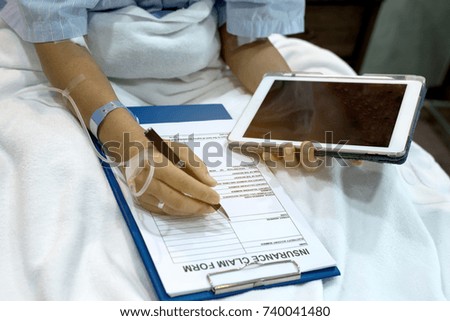  Insurance claim form put on patient's bed in hospital room with pen, prepare for patient write claim insurance.