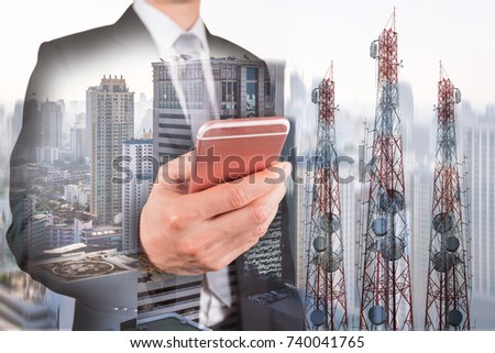 Double exposure of businessman use smartphone, communication tower or 4G 5G network telephone cellsite and foggy cityscape urban background as business, technology and telecom concept Royalty-Free Stock Photo #740041765