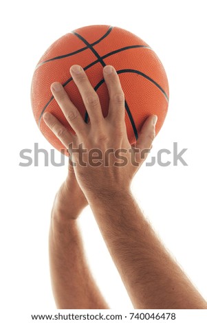 Male hand with basketball isolated on white background. Man holding ball, sport equipment and recreation concept.