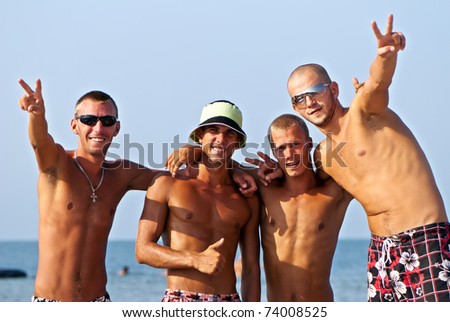 Joyful team of friends having fun at the beach Royalty-Free Stock Photo #74008525