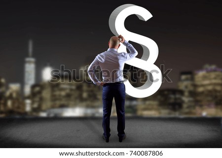 View of a Businessman in front of a wall with a justice and law symbol displayed on a futuristic interface - Technology and business concept