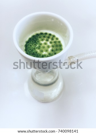 Büchner funnel suction with filtering flask for filter waste water solution and green fungi precipitate solids on filter paper in Evitomental health laboratory use as a background and science object.