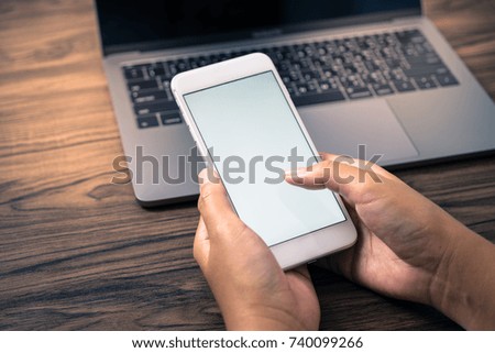 woman hand mobile smart phone on table using blank white screen display business background and technology