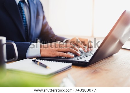 Businessman that operate on table wood being checking data, Concept financial transactions online of businessman, Financier being check about financial transaction past computer.
