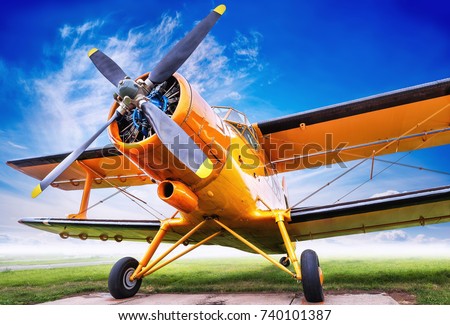 biplane against a cloudy sky Royalty-Free Stock Photo #740101387
