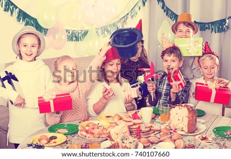 Group of children exchanging gifts with each other during party