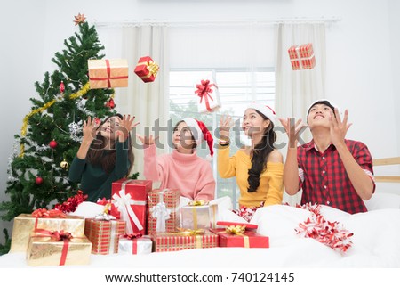 Picture showing group of friends celebrating Christmas and happy with to redeem a gift at home