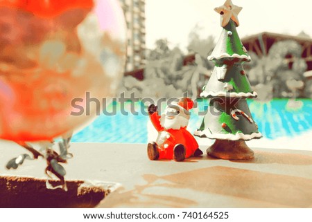 santa doll with christmas tree ,pool background
