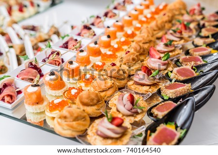 Gourmet appetizers: caviar, venison, tuna and salmon. Royalty-Free Stock Photo #740164540