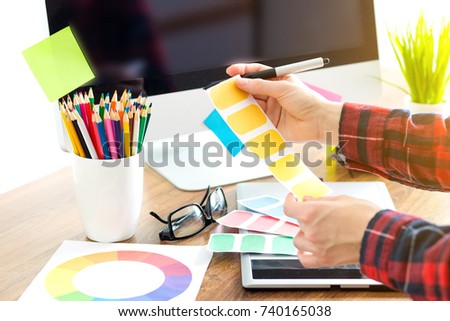 Modern designer sitting in front of computer in office