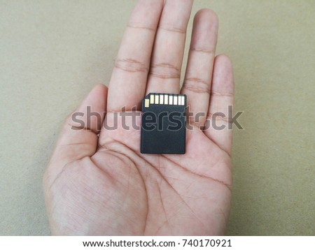 SD Card memory black color on hand selective focus