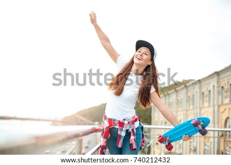 Young woman with skateboard outdoors active lifestyle