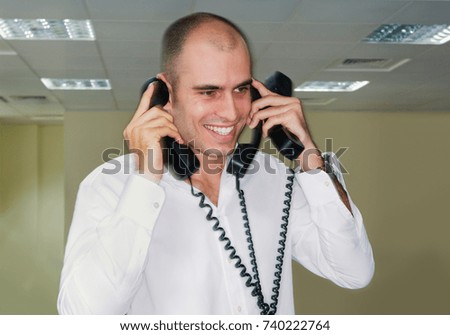 Office worker holding three phones
