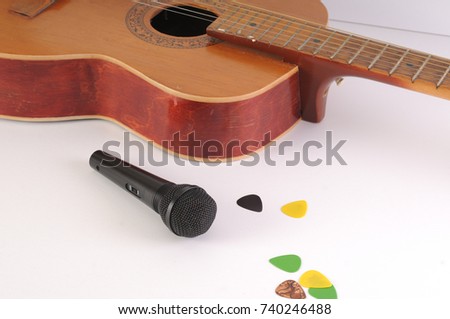 Guitar and microphone on a white background