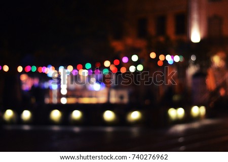 Night city lifestyle blurry background. City street blurry photo. Streetlife bokeh abstract image. 