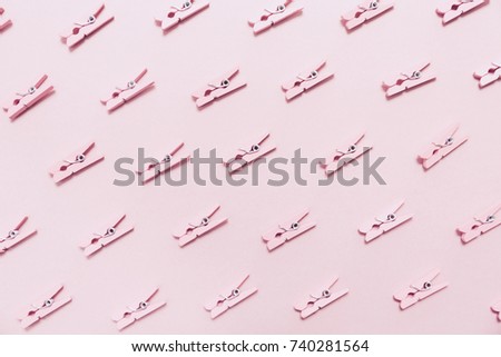 Pink clothes pins on the pink background. Horizontal