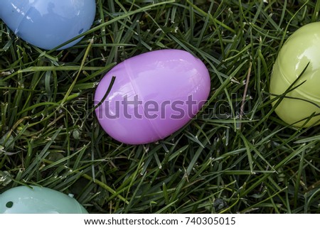 Plastic easter eggs laying in the green grass
