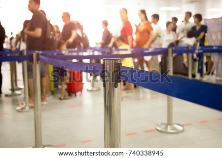 Passengers check-in line at the airport on vacation Royalty-Free Stock Photo #740338945