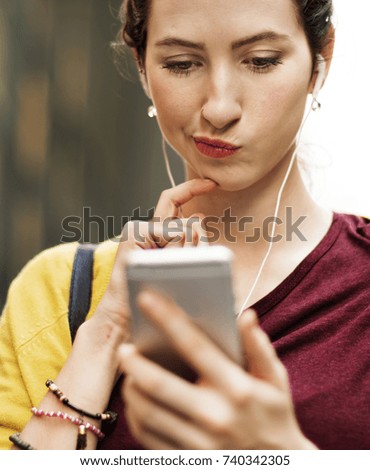 Young woman playing on her phone