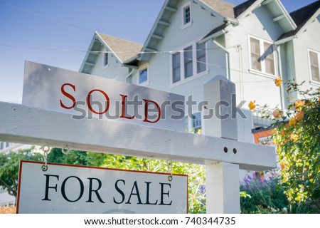 Sold sign in front of a house in a residential neighborhood, California
