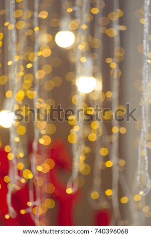 Christmas garland beautifully lit in the distance. The picture is blurred, there was a beautiful bokeh.