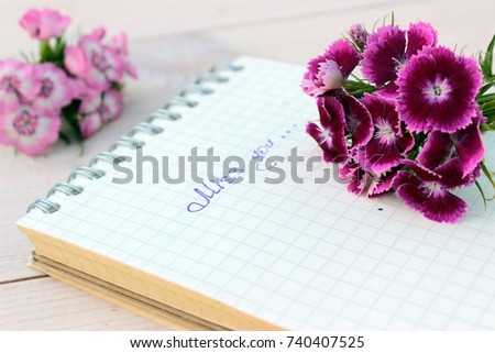 Dreaming and love theme. Card with bunch of pink flowers and paper shirt with handwritten text "Miss you". Simple composition