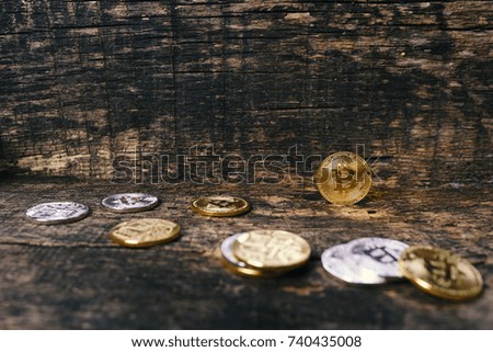 Many golden and silver bitcoins on a wooden surface, background with vintage effect, cryptocurrency concept for business idea, set