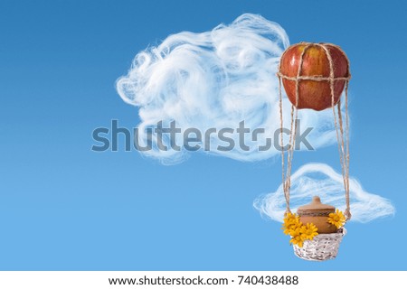 concept with apple as balloon, basket with honey attached