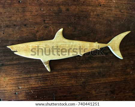 Wooden Shark Sculpture on the vintage wooden table.