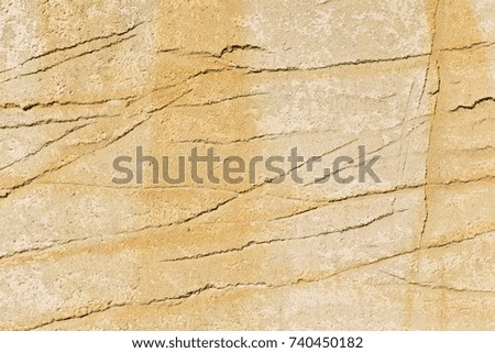 Beige wall with dirty yellow scratched