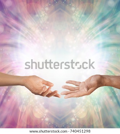 Male and Female energy merging - a female hand and a male hand with open palms facing each other against a beautiful intricate masculine and feminine colored energy background with copy space above
 Royalty-Free Stock Photo #740451298