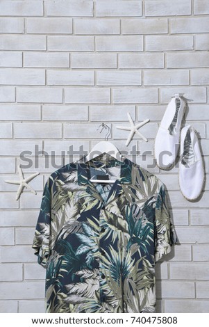 Palm leaves pattern. painted sundress clothes hanging with white shoes,starfish –wall background