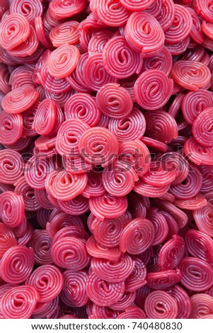 Colorful candy wheels red purple. Licorice candies wheels as full background.