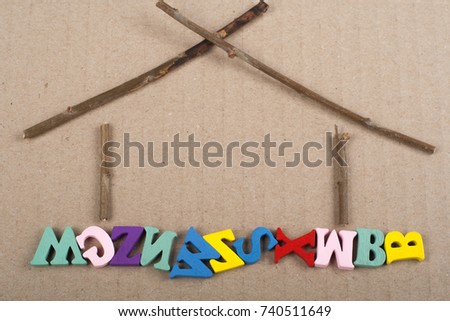 HOME word on paper background composed from colorful abc alphabet block wooden letters, copy space for ad text. Learning english concept