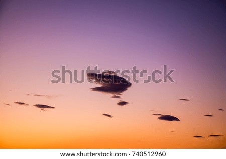 Beautiful vivid and colorful sunrise/sunset background with light clouds.
