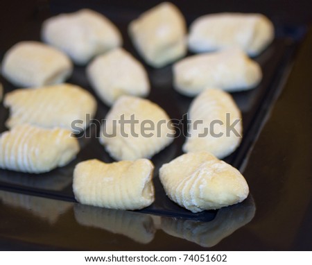 Close up of Italian home made gnocchi on a black plate