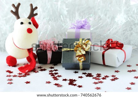 snowman posed next to gifts with shiny knots on a Christmas holiday decor
