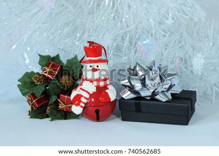 snowman posed next to gifts with shiny knots on a Christmas holiday decor