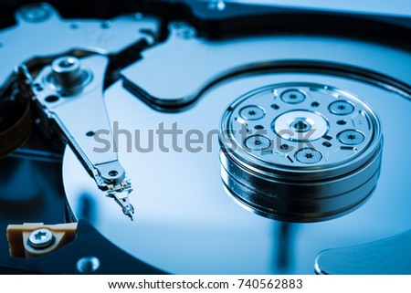 computer data storage hard disk drive head stack parts electronic device technology blue background closeup