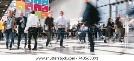 anonymous blurred business people at a trade fair 