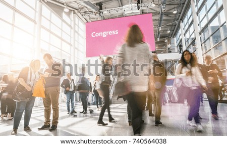 crowd of anonymous business people rushing at a congress