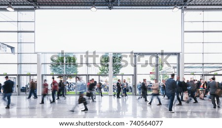 Anonymous Crowd of business people walking at a trade fair - concept image