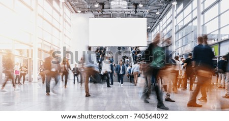 anonymous blurred people at a tradeshow