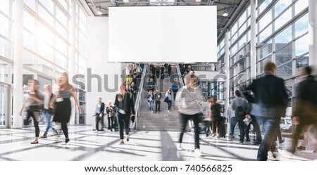 crowd of anonymous people walking at a trade fair 