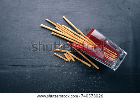 Salt sticks, snack for beer. On a wooden background. Top view. Free space for your text.