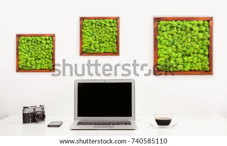 Minimalistic workplace with notebook, camera, mobile and cup of coffee. White background. Stylish modern sparse interior working place.