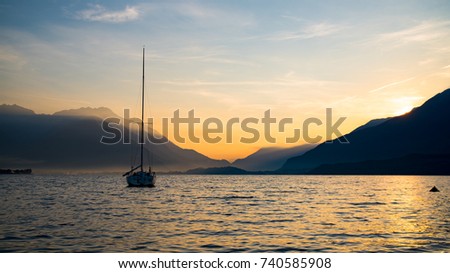 Sunrise on Lake Como with a boat on the water