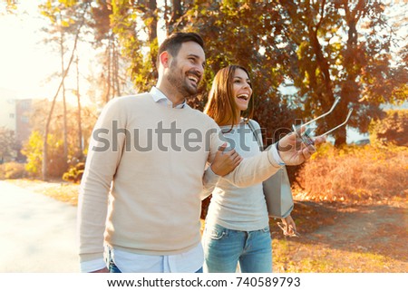 Happy couple in love having fun outdoors and smiling.